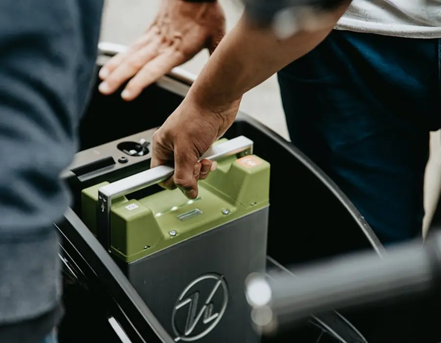A technician carrying a sealed battery
